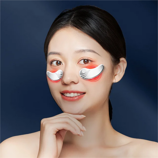 Woman using GlowEyes™ Red Light Under-Eye Massager
